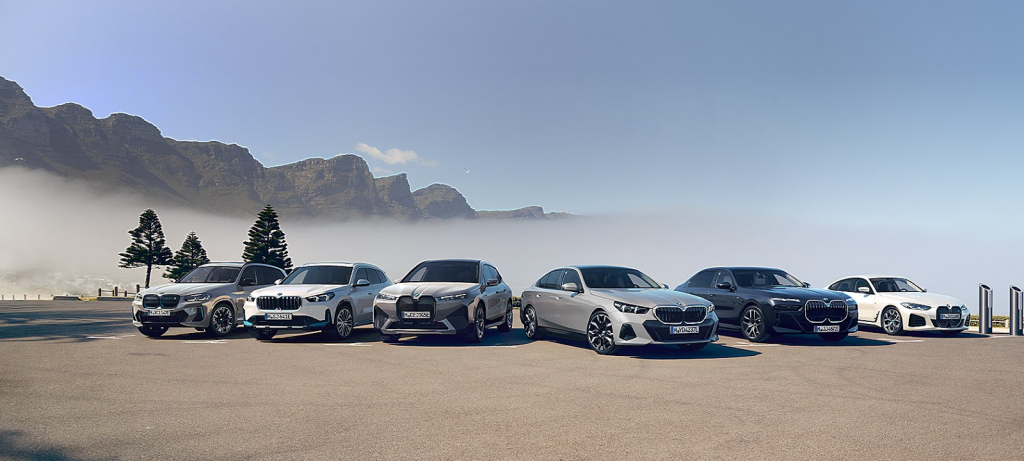 BMW electric and luxury car lineup with mountain background