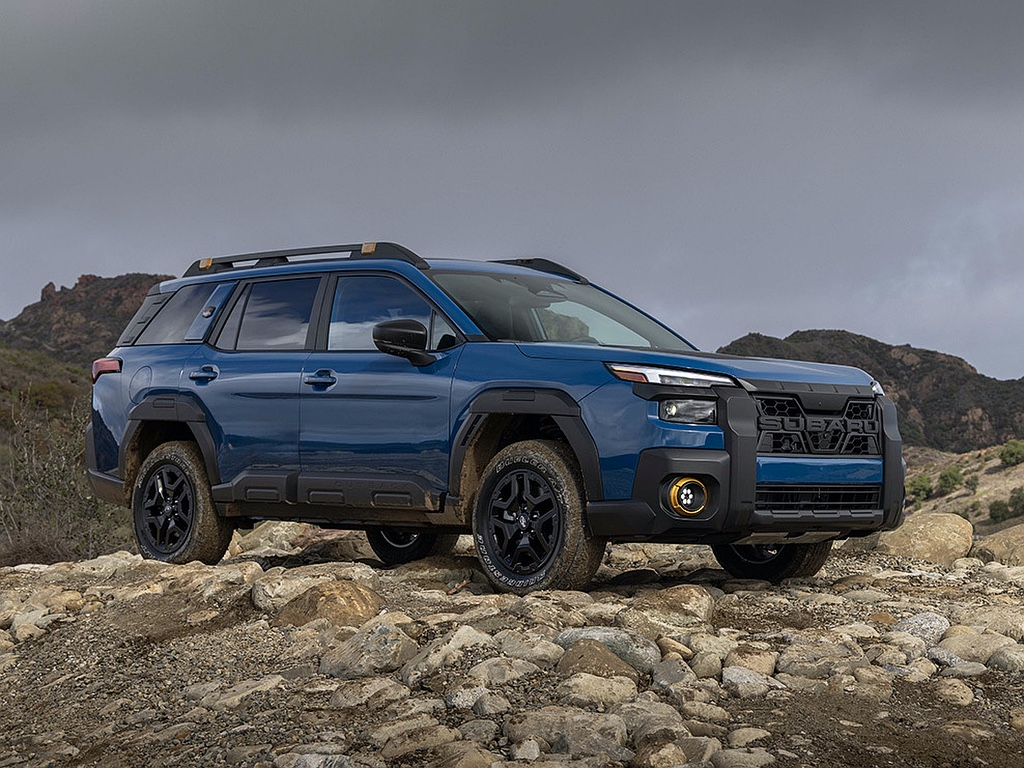 Blue 4WD SUV off-roading on rocky terrain